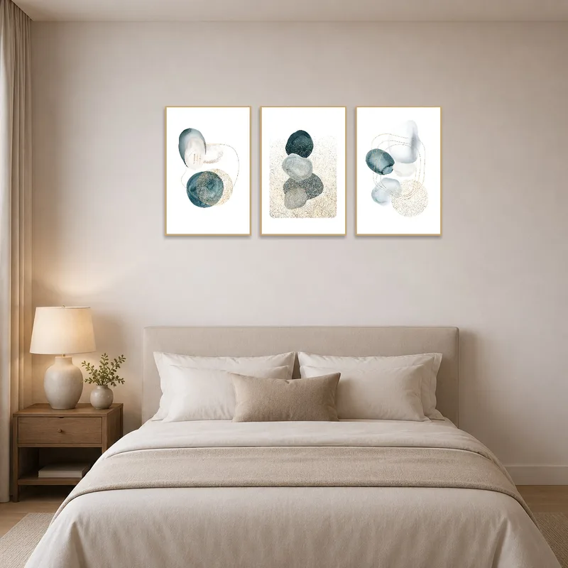 Abstract triptych with gold accents adds warmth and style to a tranquil bedroom.