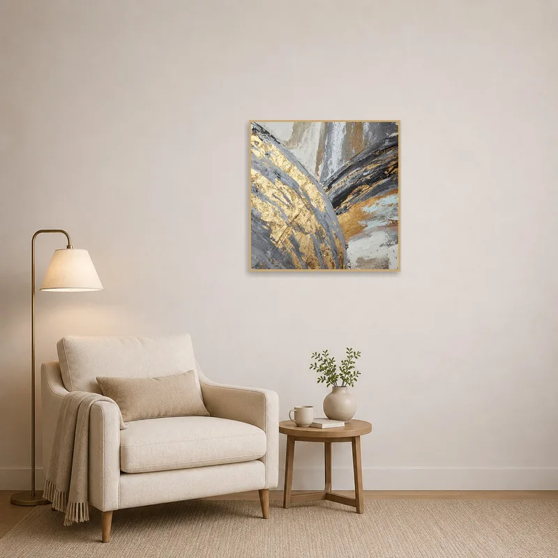 Cozy reading corner featuring gold and gray abstract textured art.