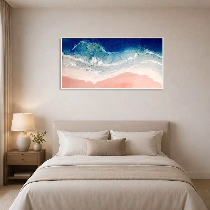 Serene ocean art compliments a calming bedroom space.