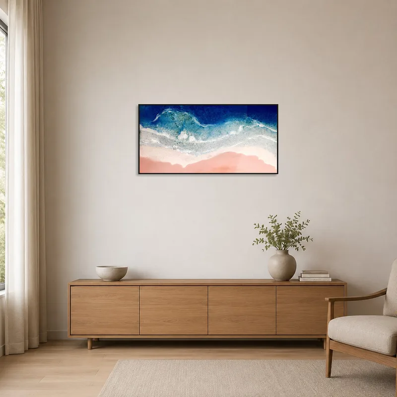 Abstract ocean art hangs in a minimalist room setting.