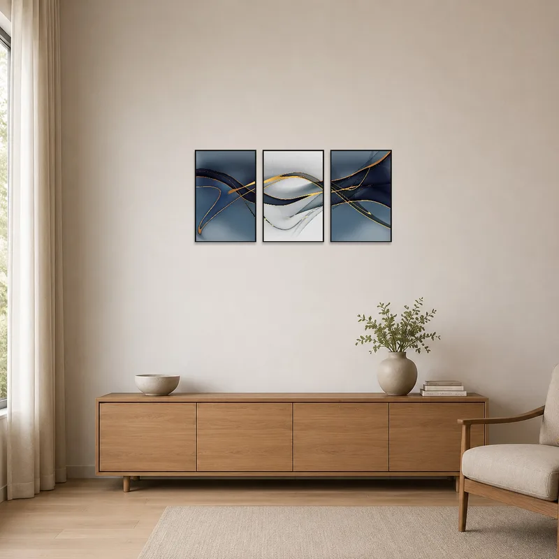 Minimalist space featuring abstract triptych with gold details on a blank wall.