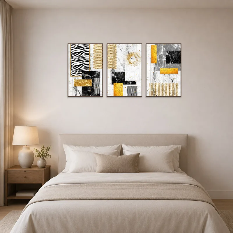 A serene bedroom featuring a contemporary gold and marble abstract triptych above the bed.