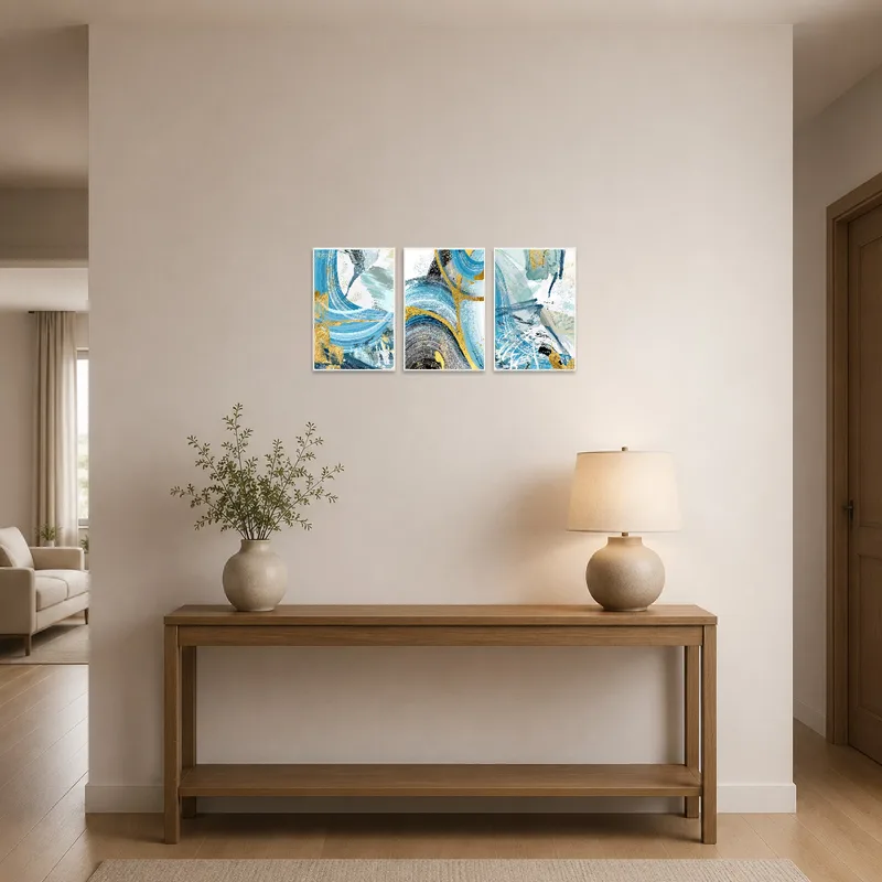 Bold abstract triptych with gold details in a stylish entrance hall over a console table.