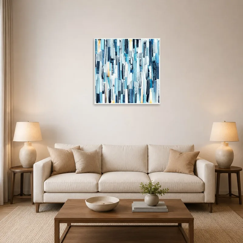 A vertical blue abstract artwork on a living room wall, complementing cozy sofas and a coffee table.