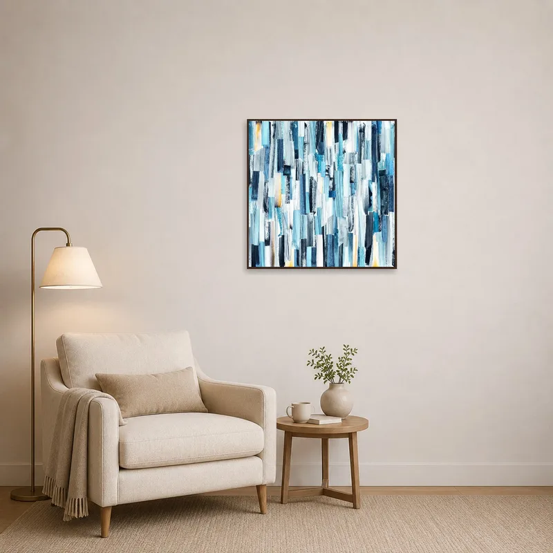 Dynamic blue abstract piece enhancing a reading corner with an armchair and a small bookcase.