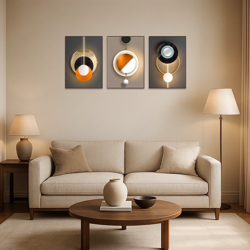 Geometric abstract triptych art set on a living room wall above a modern sofa.