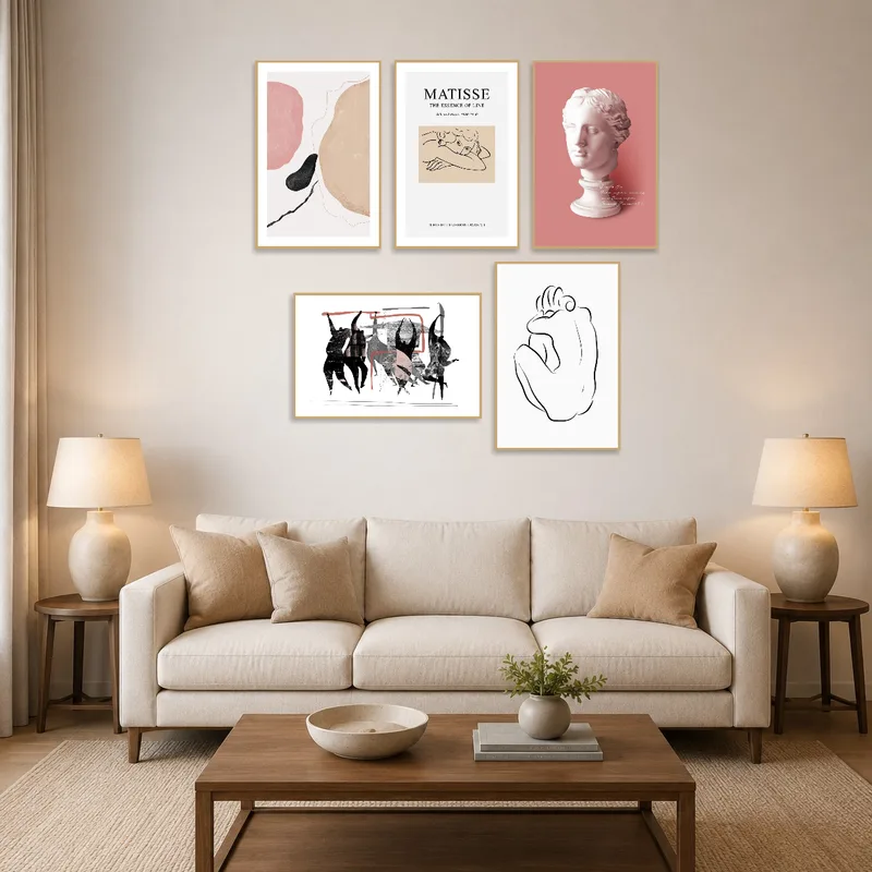 Abstract and classical art prints above a contemporary living room sofa with cozy cushions.