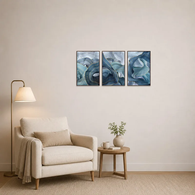 Serene blue wave triptych print creating a tranquil atmosphere in a cozy reading corner.