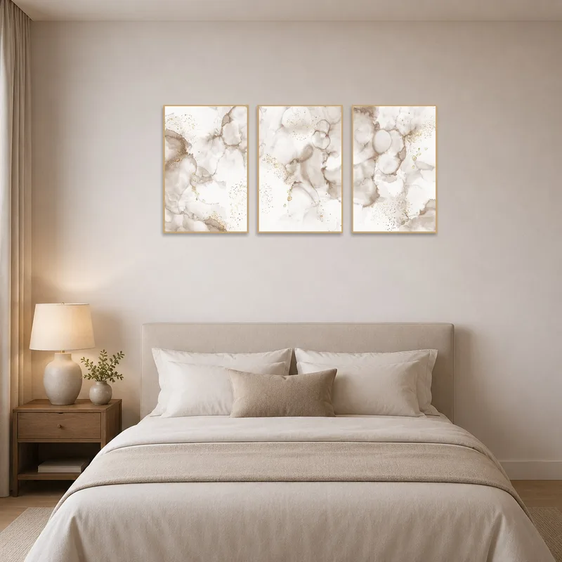 Bedroom adorned with a serene abstract neutral and gold triptych over the bed.