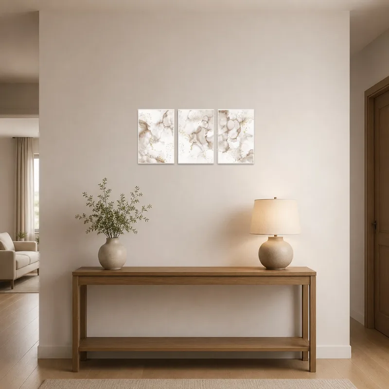 Entrance hall featuring a sophisticated abstract gold and neutral triptych.