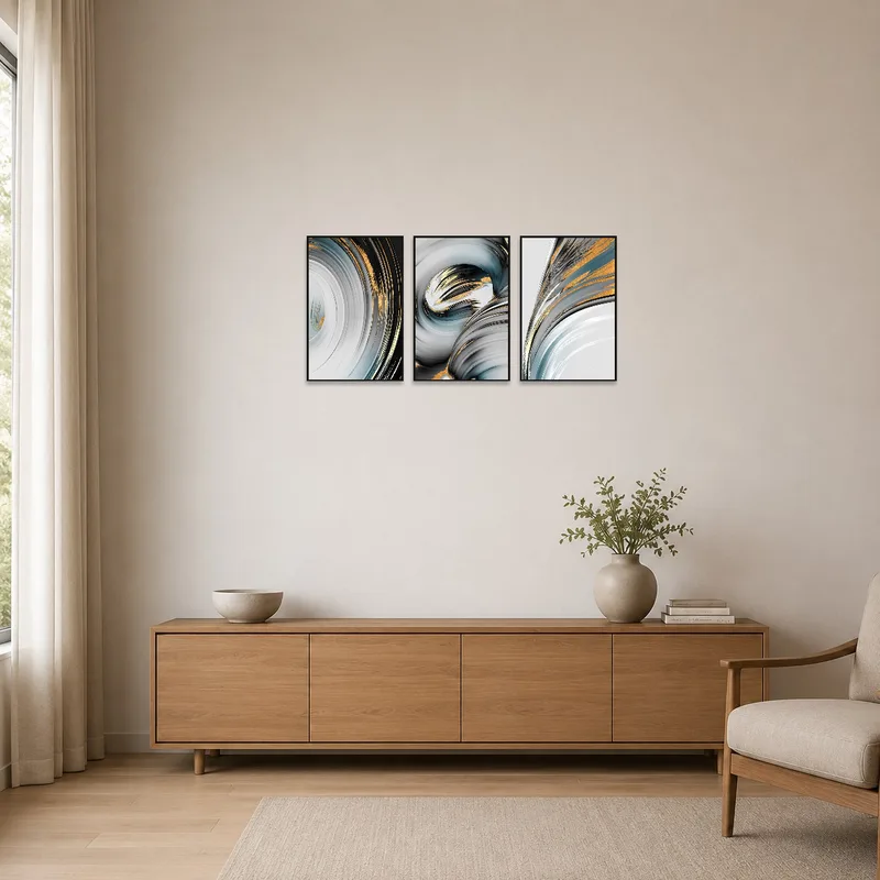 Sleek swirl triptych leaning against a stark white wall.