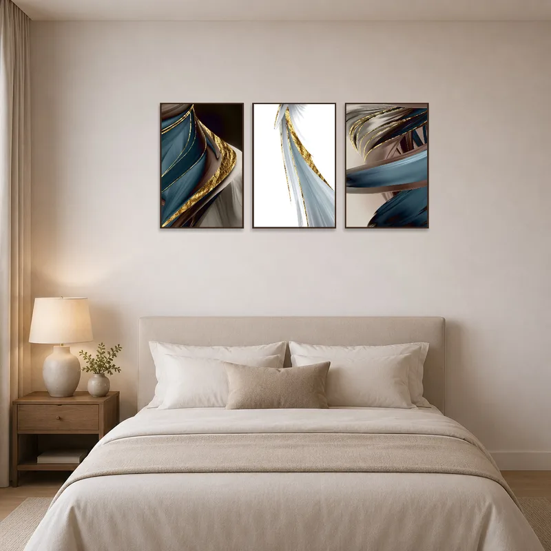 Elegant abstract triptych with gold accents as a bedroom focal point.
