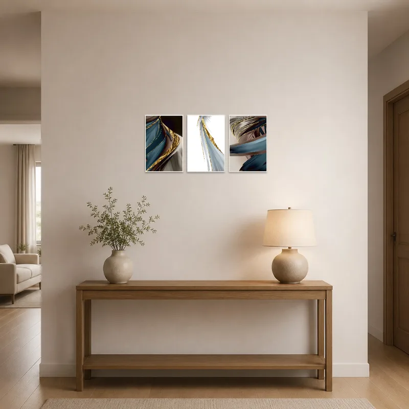 Triptych art with gold touches welcoming guests in an entrance hall.