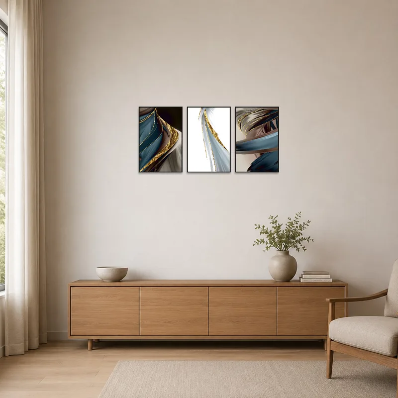 Abstract triptych with gold highlights on a minimalist white wall.