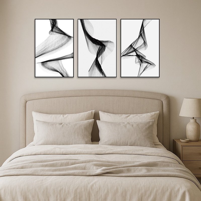 Abstract artwork set invites tranquility in a monochrome-themed bedroom.