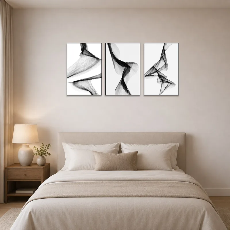 Sophisticated triptych art above a contemporary bed.