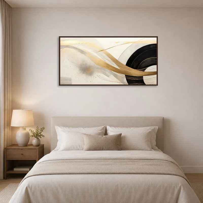 Gold and black art enhancing a serene and chic bedroom.