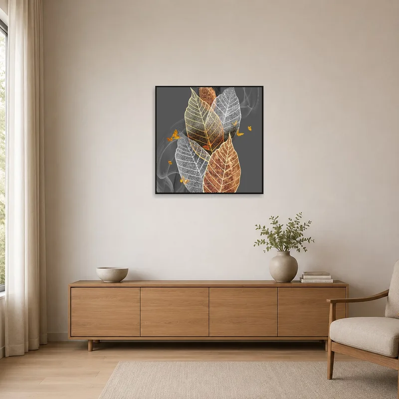 Art of gold-accented leaves in a minimalist white room.