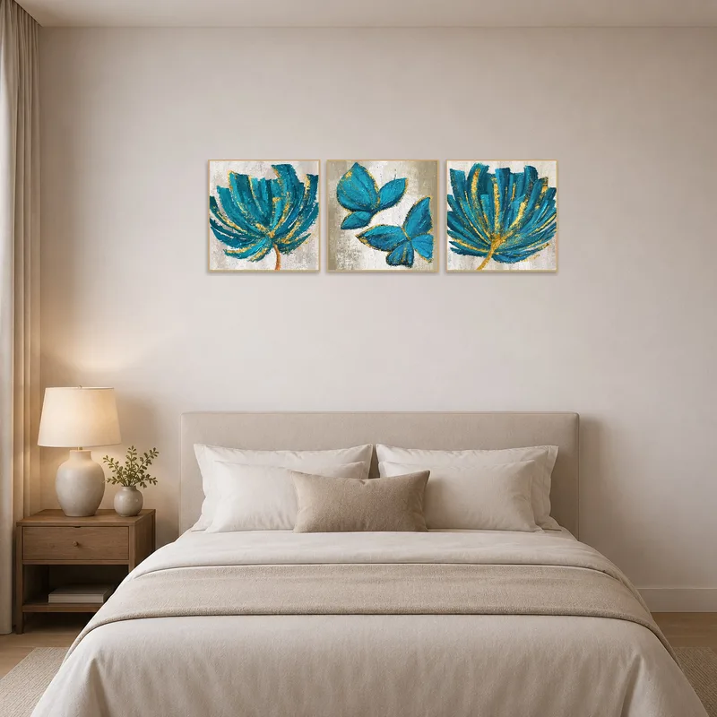 Teal and gold botanical triptych adding elegance to a serene bedroom space.