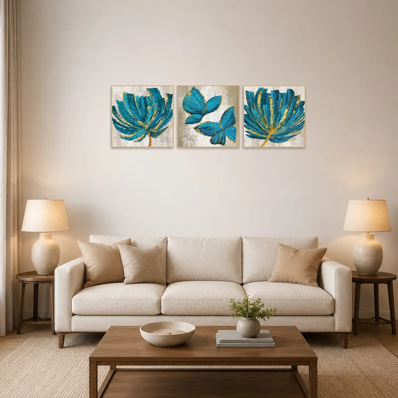 Elegant teal botanical triptych with gold accents in a bright, airy living room.