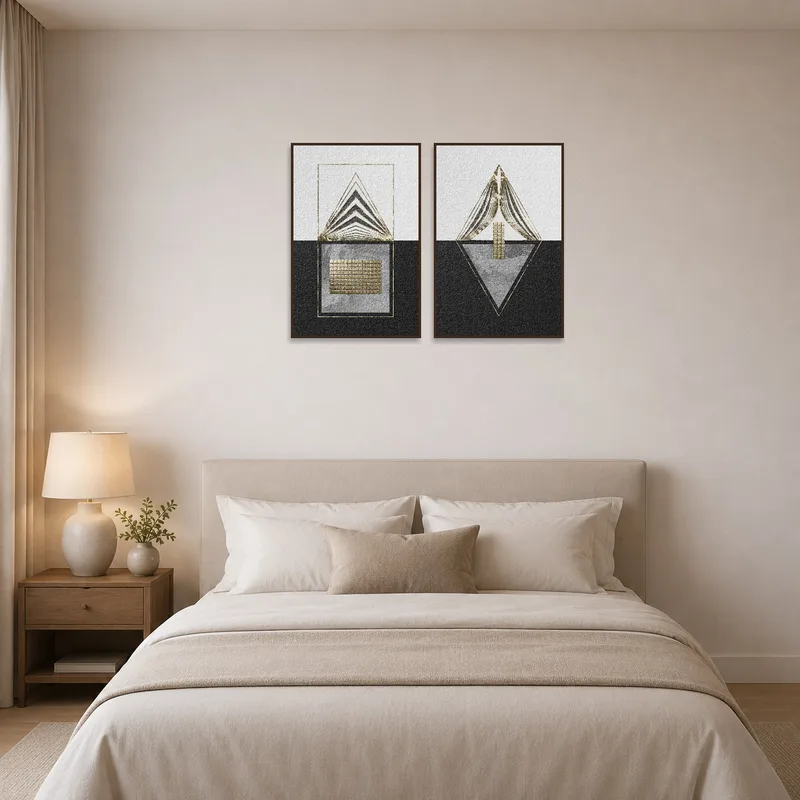 Geometric textured art set in gold and black displayed above a bed with neutral bedding.