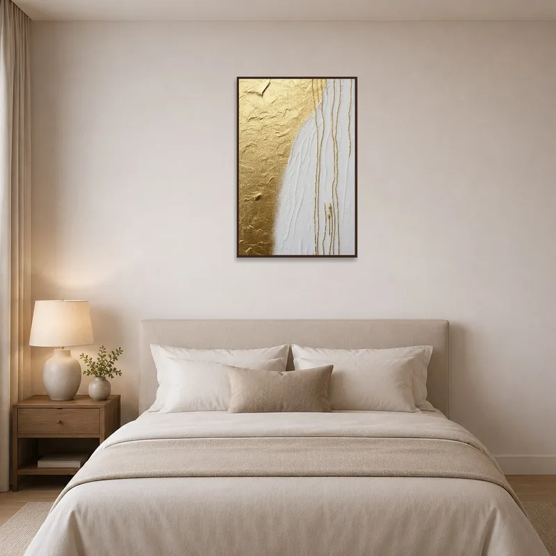 Golden and white abstract artwork adding elegance to a serene bedroom setting.
