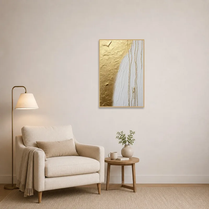 Reading corner featuring a cozy chair and bright abstract art with gold and white hues.