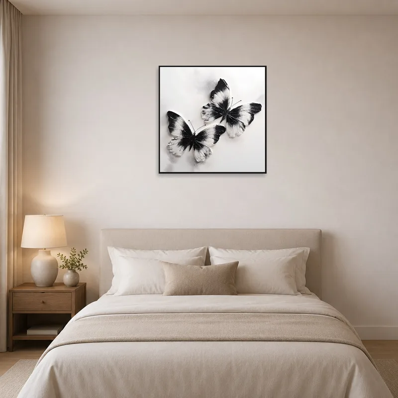 Elegant black and white butterflies adorn the wall above a tranquil bed setting.