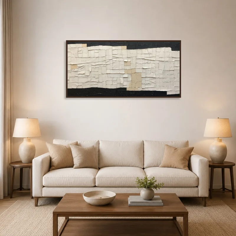 Textured abstract tapestry in neutral tones hanging on a living room wall.