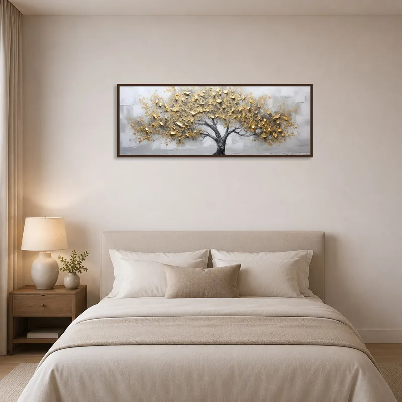 Bedroom wall showcases a gold leaf tree art print next to a bed.